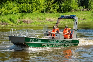 Funkcjonariusze SG podczas służby na łodzi patrolują rzekę graniczną Bug